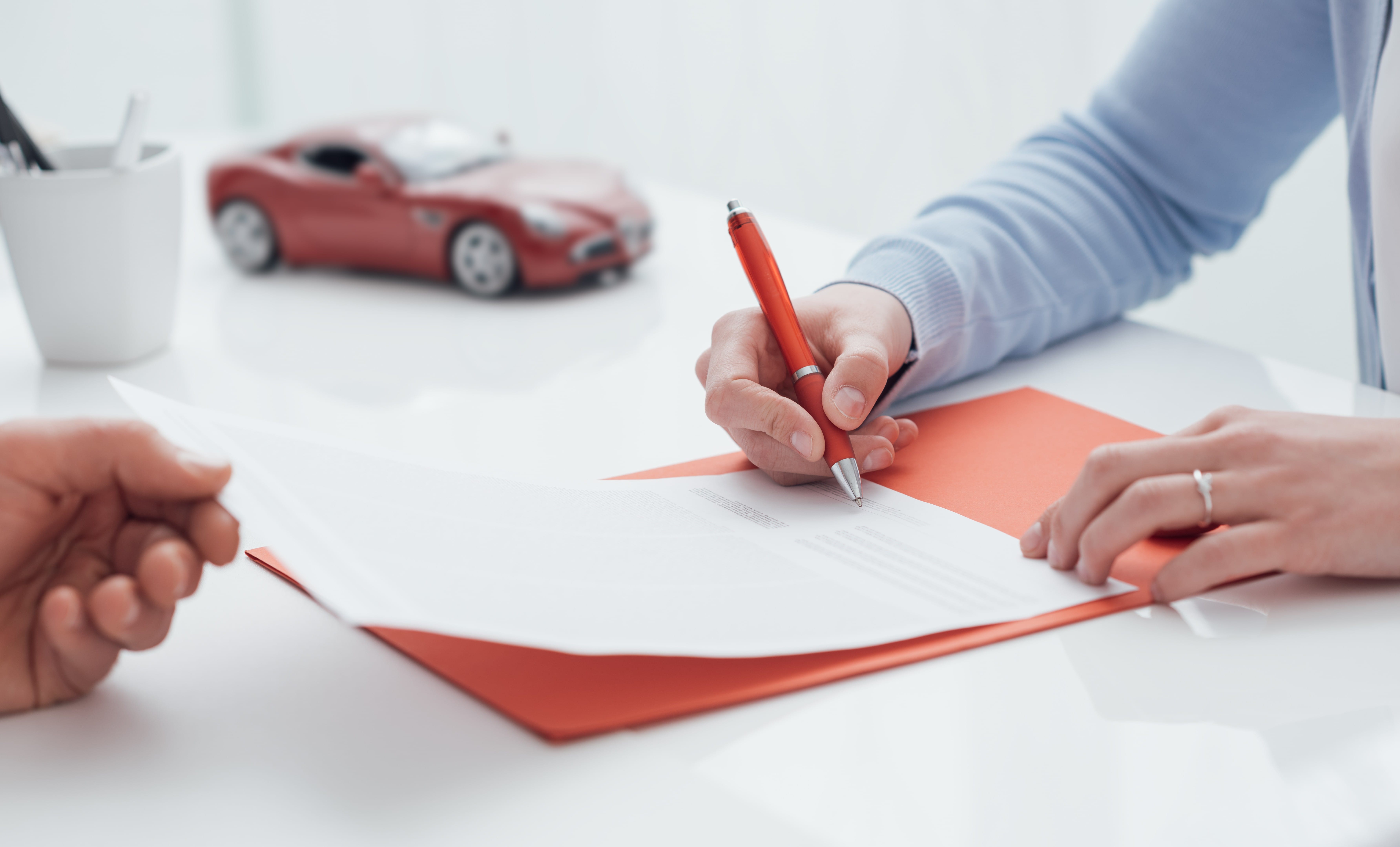 Woman Signing A Car Insurance Policy
